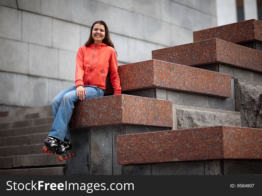 Portrait of rollerskating girl on granite stairs - shallow DOF