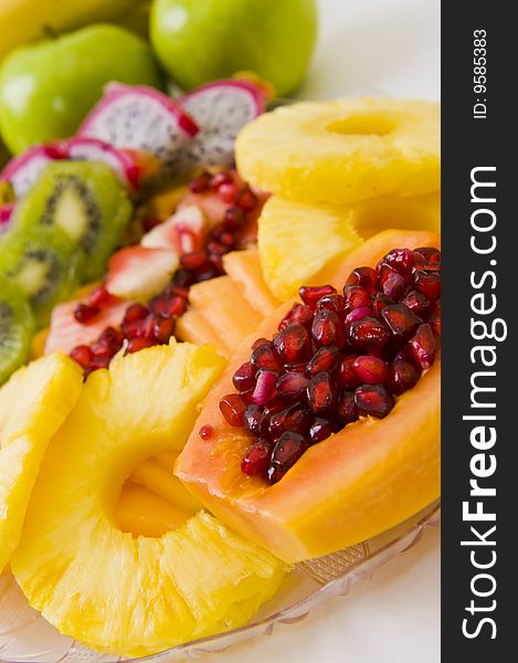 Delicious freshly cut fruit salad with pomegranate seeds inside a papaya and other fruit. Delicious freshly cut fruit salad with pomegranate seeds inside a papaya and other fruit.