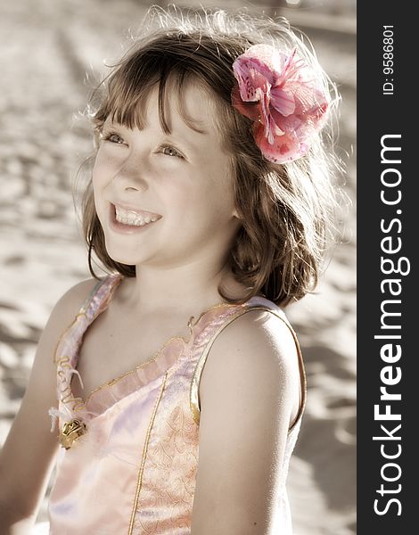 A portrait view of a smiling young 7-year old girl in a fairy ballerina dress or costume. A portrait view of a smiling young 7-year old girl in a fairy ballerina dress or costume.