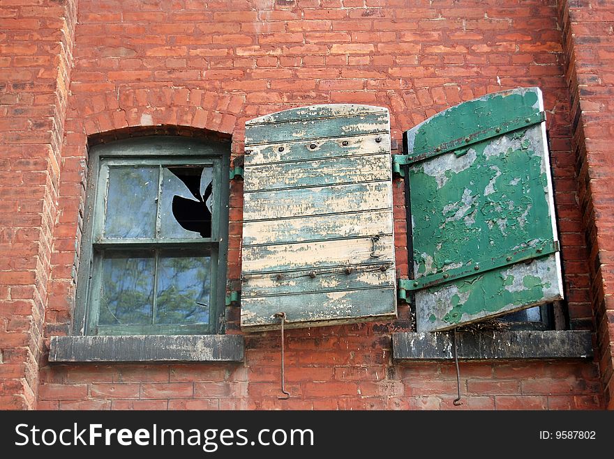 Old grungy brick building with broken windows