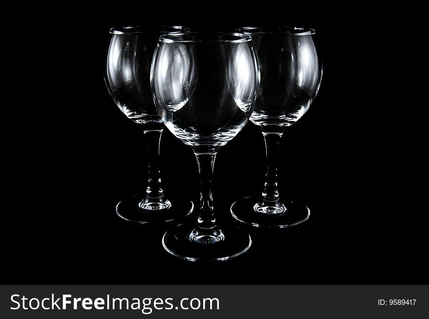 Empty cocktail glasses on black