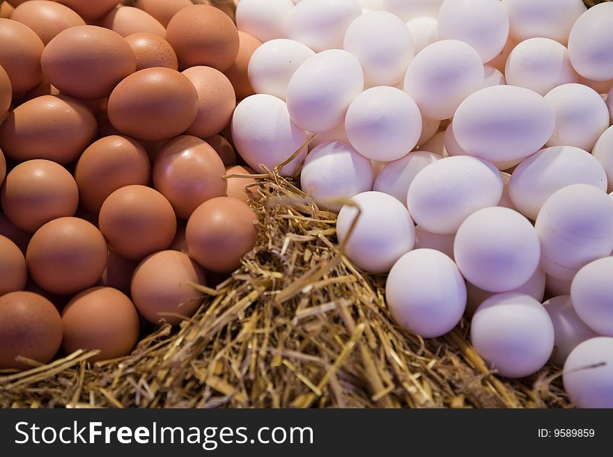 Fresh white and brown eggs on the market.