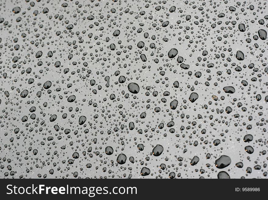Water drops on the black smooth background