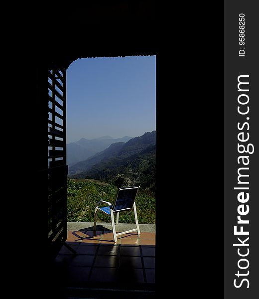 Blue and White Empty Armchair during Daytime Outside With Mountain Range Under Blue Sky during Daytime