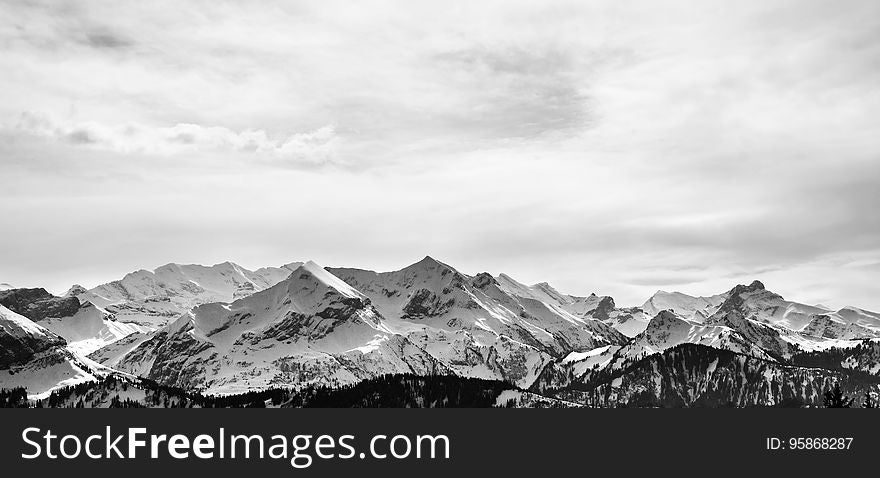 Panorama of snow covered mountain range landscape in black and white with copy space. Panorama of snow covered mountain range landscape in black and white with copy space.