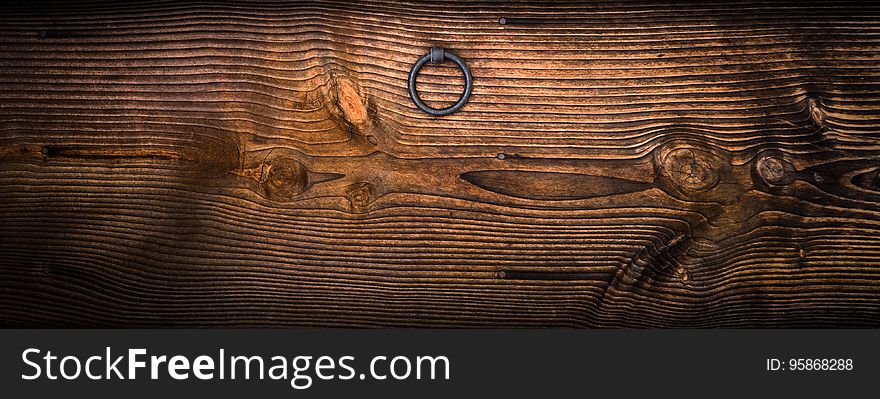 Gray Metal Door Knocker on Wooden Panel