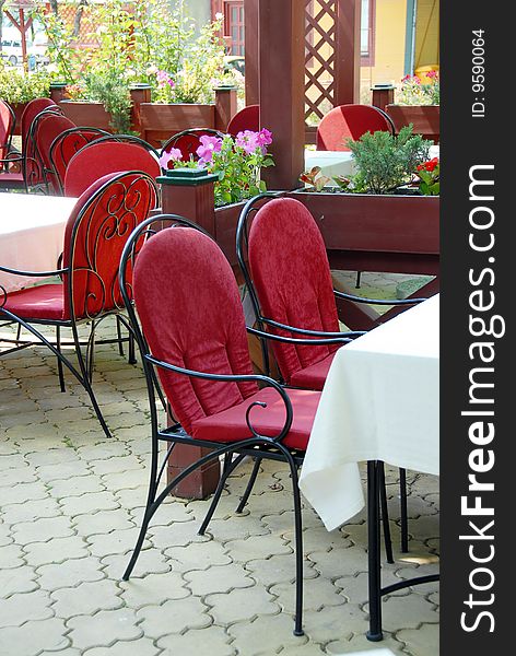 Restaurant terrace with metallic chairs and tables outdoor