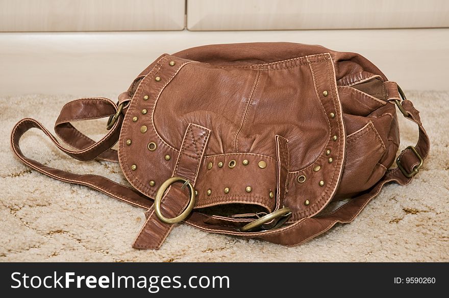 Soft brown leather handbag with light background