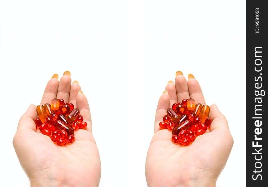 Medicine capsules in human hands isolated on white