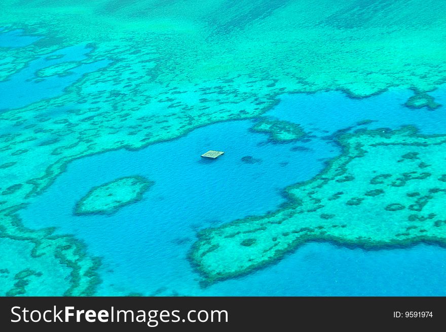 The picture is taken at the great berrier reef in Australia from a helicopter. Beautiful view on coralls and blue water