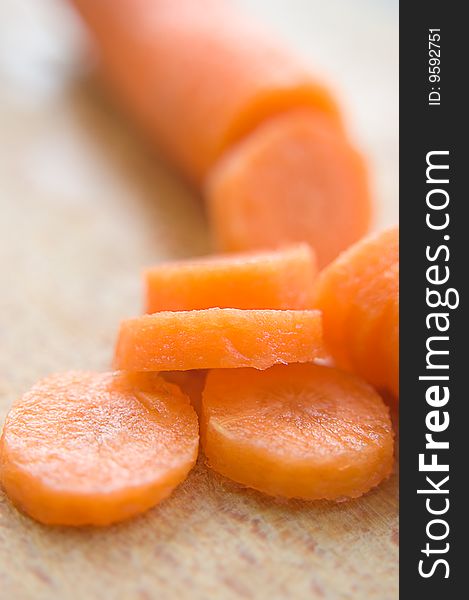 Chopped carrot in circles on wood board. Chopped carrot in circles on wood board