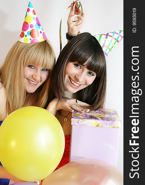 Young pretty woman in birthday cap with present box. Young pretty woman in birthday cap with present box