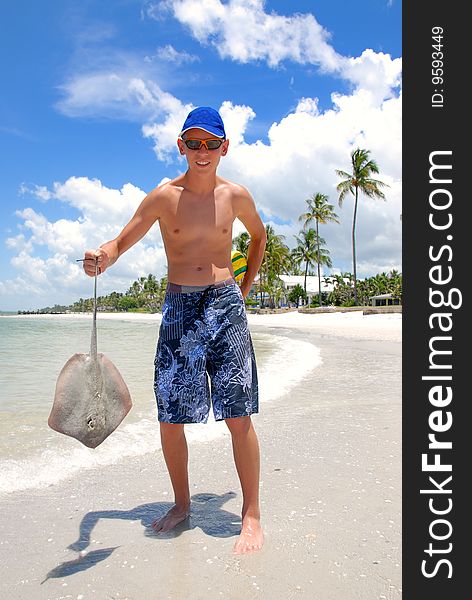 Teenager holding sting-ray on the florida beach. Teenager holding sting-ray on the florida beach