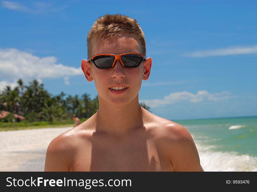 Teenager on Naples beach during his vacation. Teenager on Naples beach during his vacation.