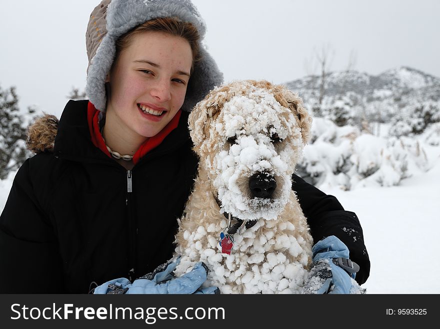 Girl holding her dog after playing in snow. Girl holding her dog after playing in snow.