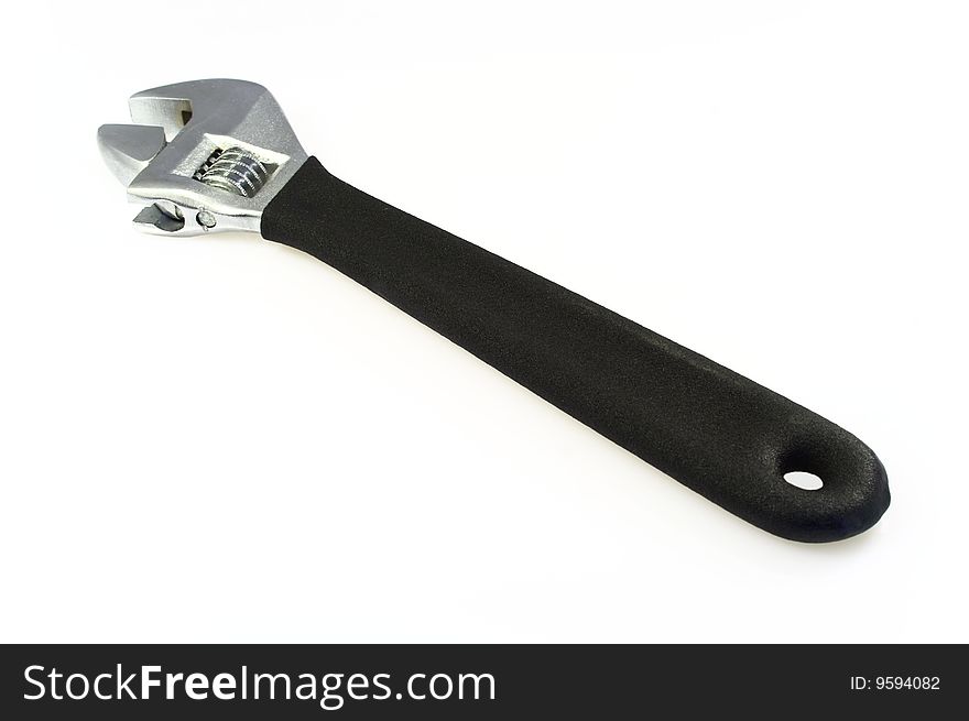 Adjustable wrench over a white background.