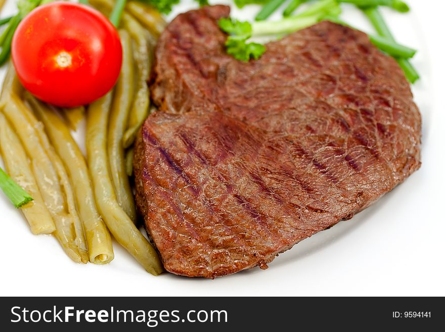 Fresh  sirloin strip steak with vegetables.