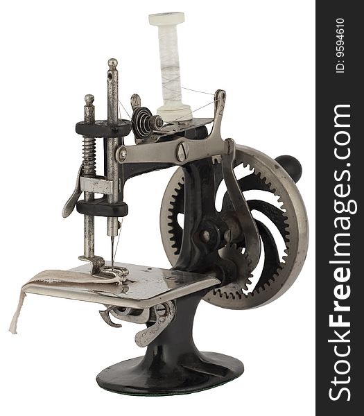 Old historical sewing machine, isoliated against white background