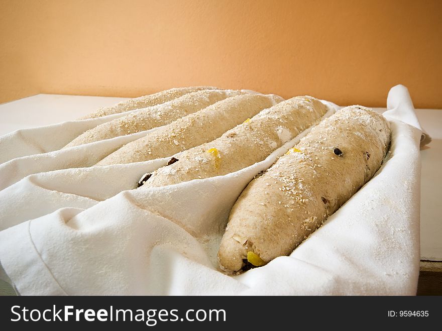 Five baguettes ready for the oven in a restaurant kitchen