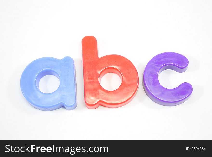 Refrigerator magnets spell out ABC on a white background. Refrigerator magnets spell out ABC on a white background.