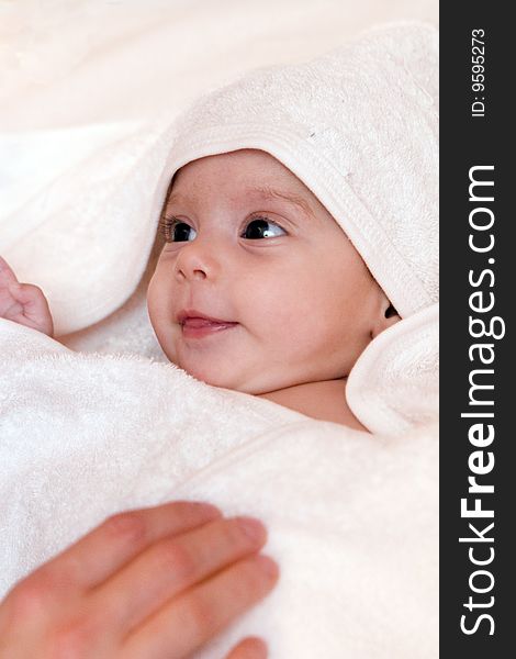 Three-month old baby girl in towel