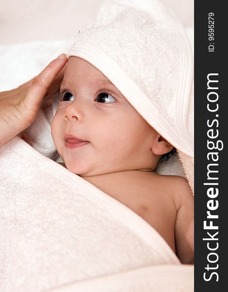 Three-month old baby girl in towel