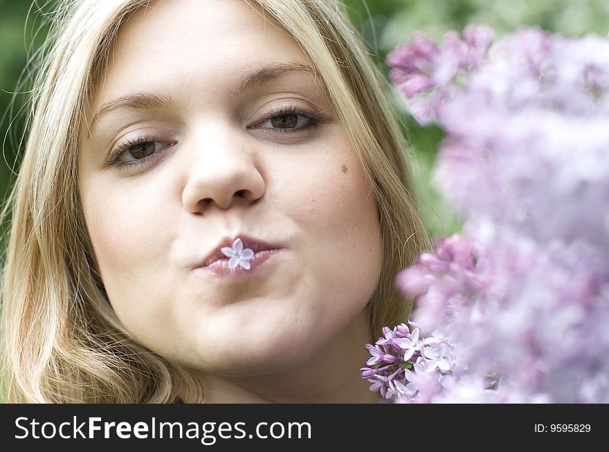 Young woman with happy lilac flower