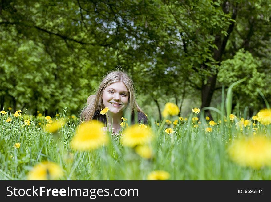 Girl lying in a meadow enjoying the sun