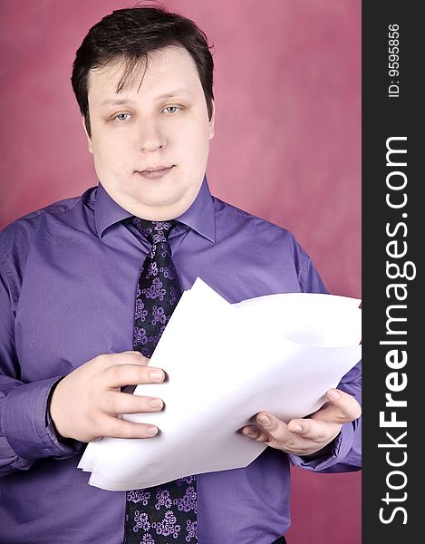 Businessman reading documents, studio shot