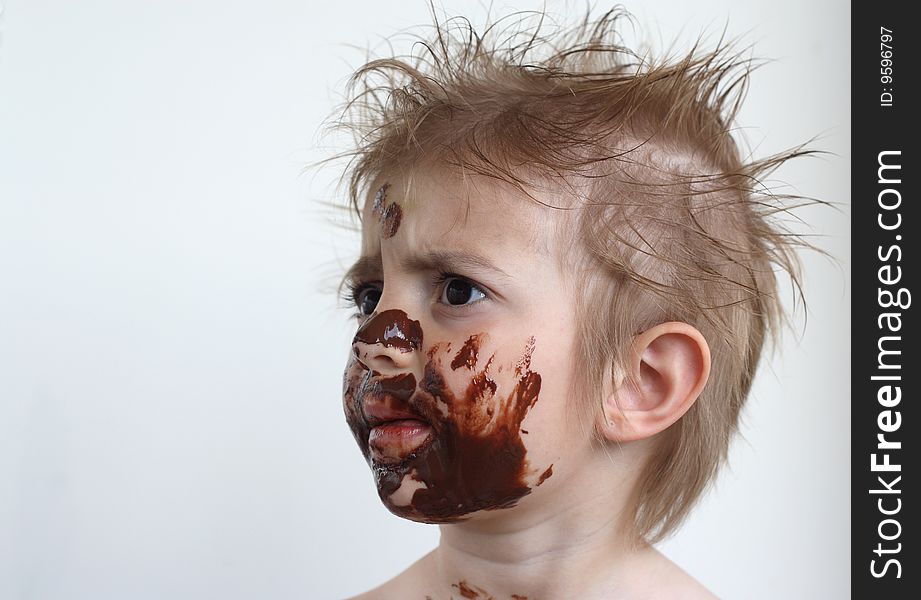 Baby with face covered in chocolate. Baby with face covered in chocolate