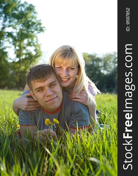 Happiness couple in love on green grass. Happiness couple in love on green grass