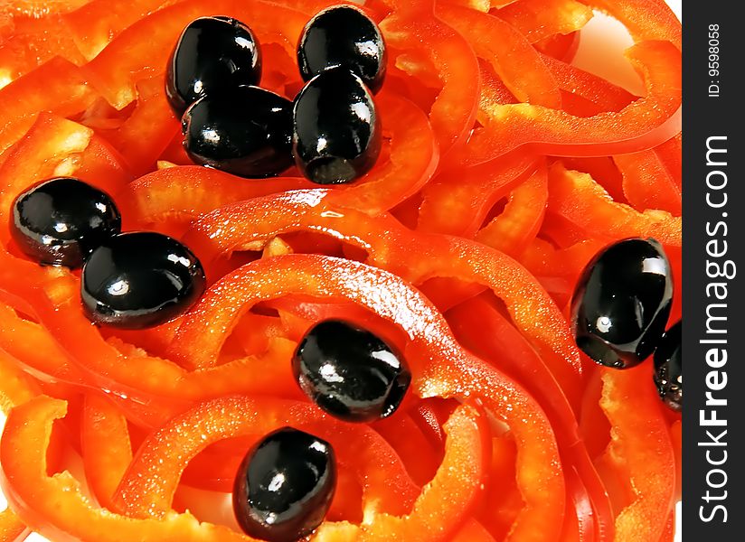 Chopped pepper and black olives on a white dish. Chopped pepper and black olives on a white dish