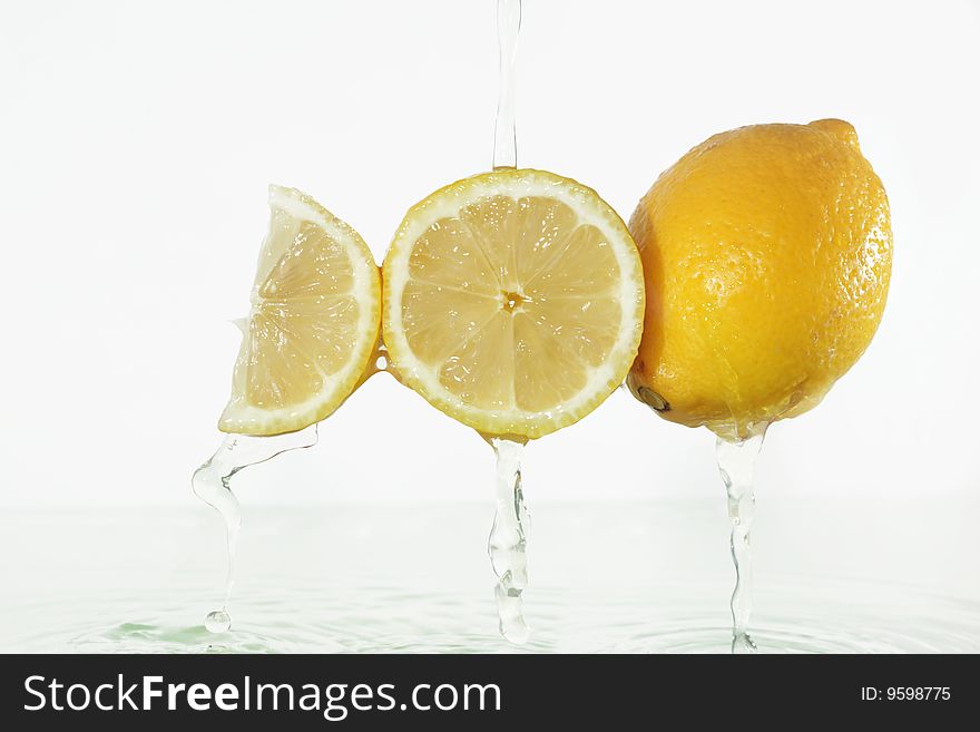 Lemon juice splashing on lemons