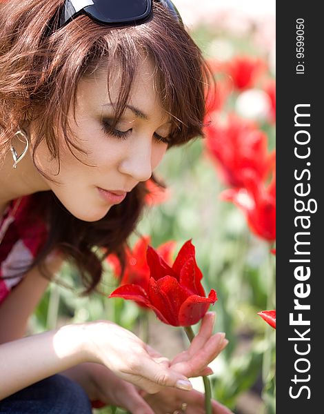 Tender girl in the garden with tulips