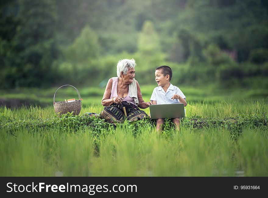 Old Woman Sitting Beside Her Grandson