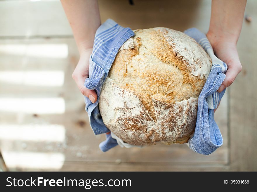 Hands Holding Hot Fresh Bread