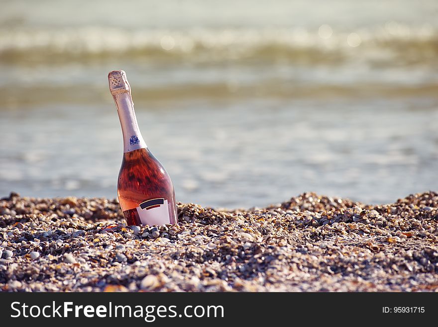 Sparkling Wine Bottle On Beach