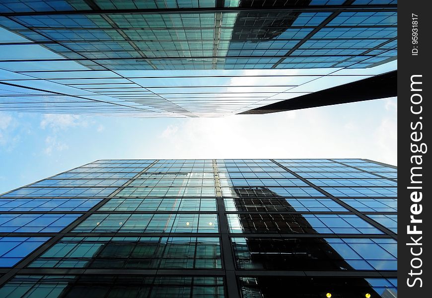 Glass and steel modern buildings from low angle against blue skies. Glass and steel modern buildings from low angle against blue skies.