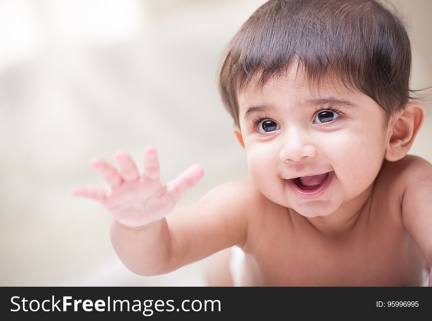 A close up portrait of a smiling baby.