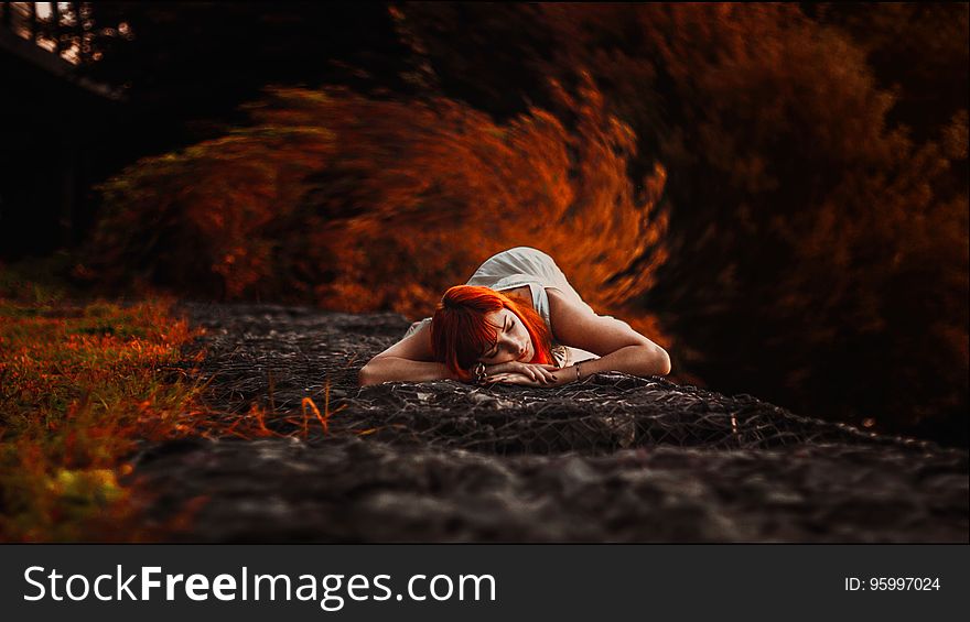 Woman In White Tank Dress Lying On Ground