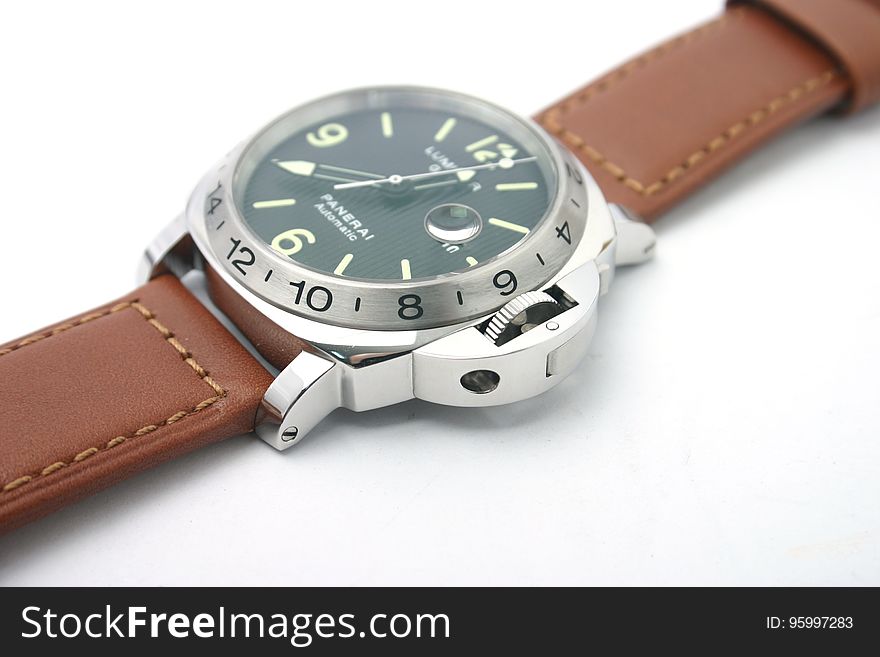 A close up of a luxury automatic watch with brown leather strap. A close up of a luxury automatic watch with brown leather strap.