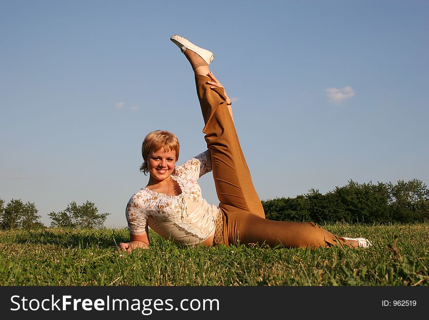 Girl lies on meadow