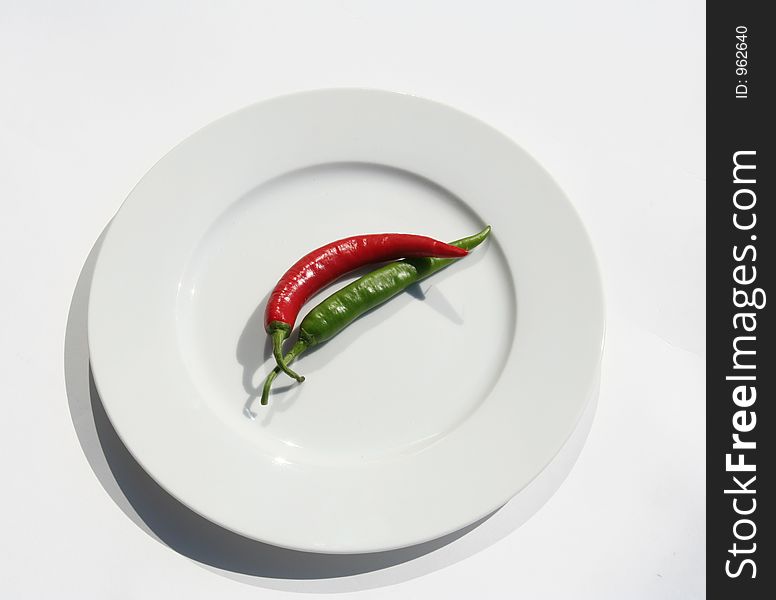 Red and green chilies on a plate. Red and green chilies on a plate