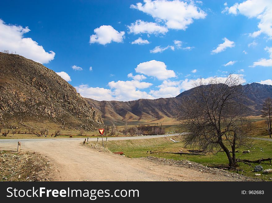 Road, mountains and skies. Russia, Altay.