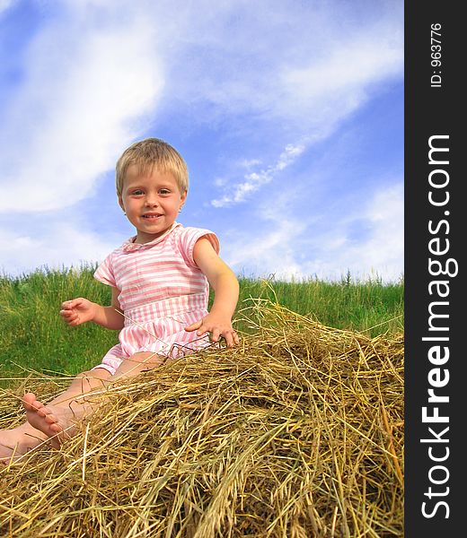 Young girl playing on a hayrack. Young girl playing on a hayrack