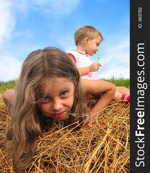 Young girls playing on a hayrack. Young girls playing on a hayrack