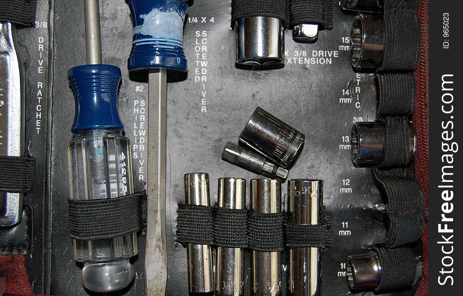 Close-up of toolkit showing various tools and parts.
