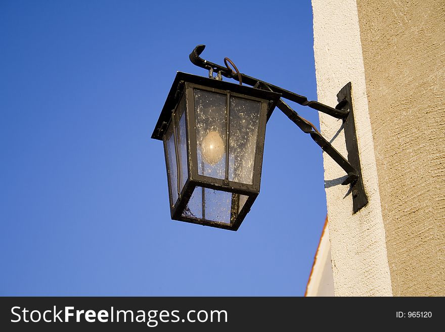 Old street lamp on blue sky