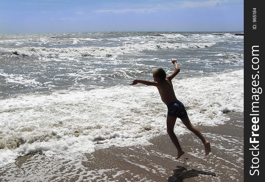 Child jumping for joy at the sea shore. Child jumping for joy at the sea shore