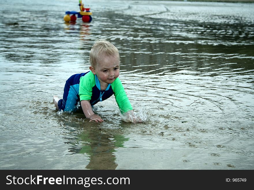 Small child exploring a beach in Cornwall. Small child exploring a beach in Cornwall.